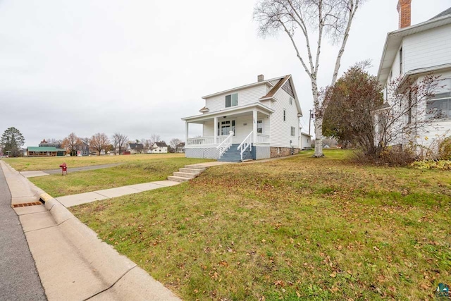 view of front facade with a front lawn and covered porch