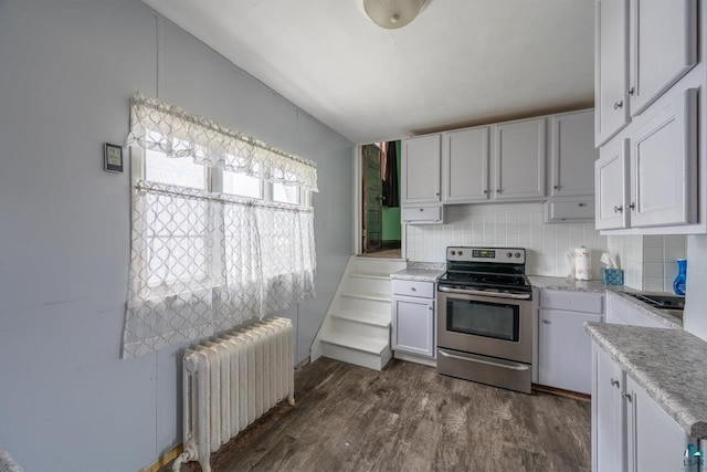 kitchen featuring radiator, white cabinets, decorative backsplash, stainless steel range with electric stovetop, and dark hardwood / wood-style floors