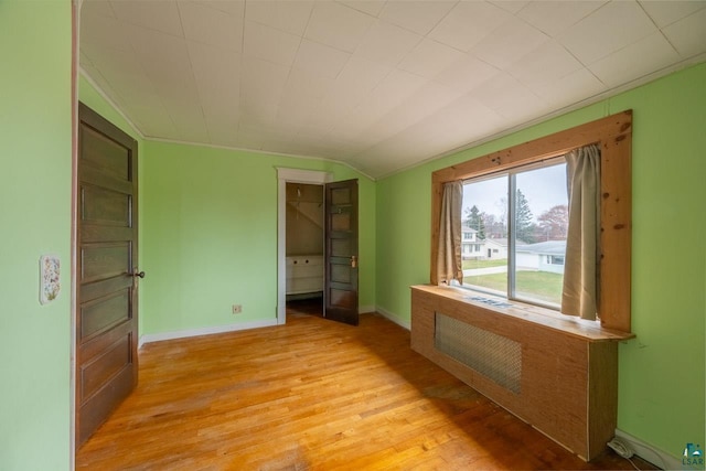 interior space with light wood-type flooring and vaulted ceiling