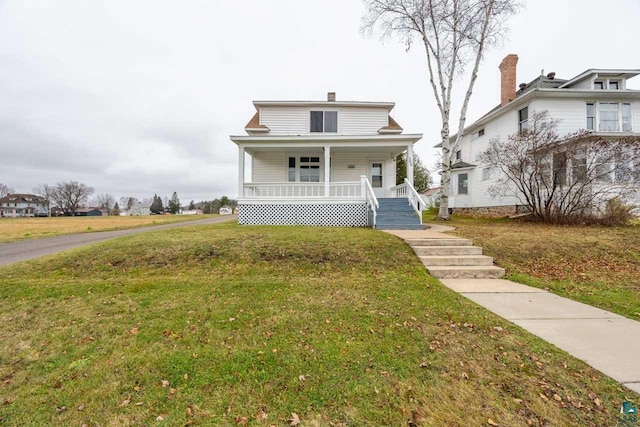 view of front facade featuring a front lawn and a porch