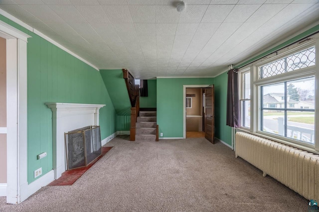 living room featuring radiator, crown molding, and carpet floors