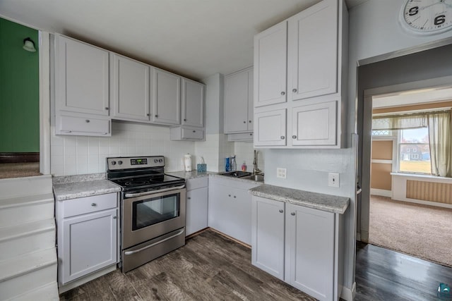 kitchen featuring sink, tasteful backsplash, white cabinets, dark wood-type flooring, and electric stove