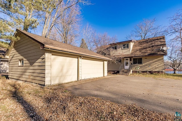 view of front of property with an outbuilding and a detached garage