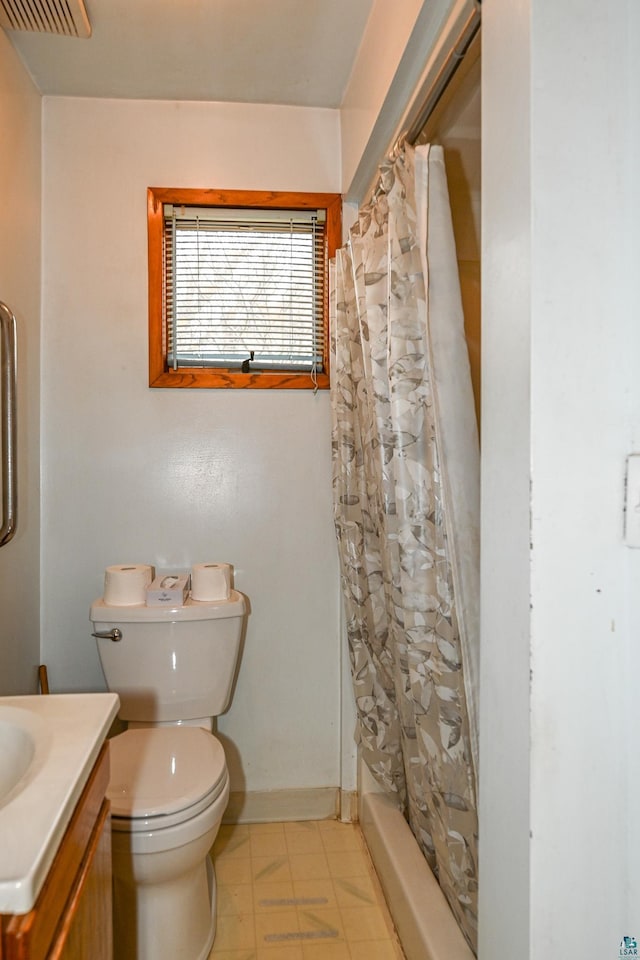 bathroom with tile patterned flooring, vanity, and toilet