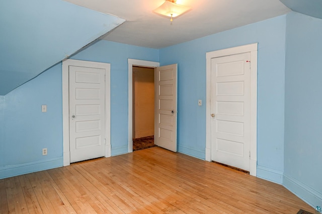 bonus room with light wood-type flooring