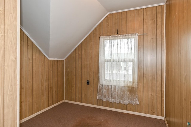 bonus room featuring wood walls, carpet floors, and lofted ceiling