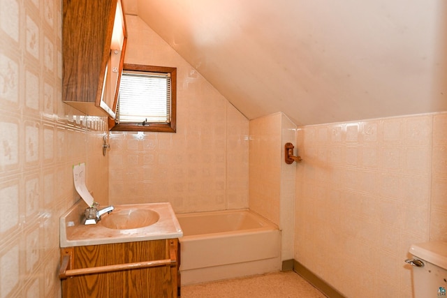 bathroom featuring vanity, toilet, and lofted ceiling