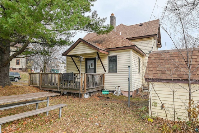 rear view of house with a wooden deck