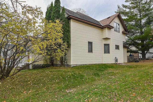 view of side of property with a lawn