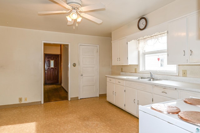 kitchen with white cabinetry, ceiling fan, and sink