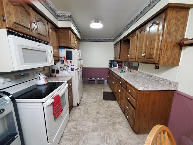 kitchen featuring white appliances and sink