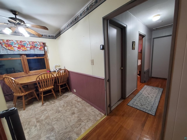 dining space with light hardwood / wood-style flooring, ceiling fan, and ornamental molding