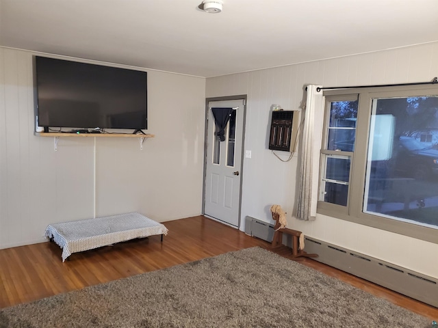 interior space with a baseboard radiator and dark hardwood / wood-style floors