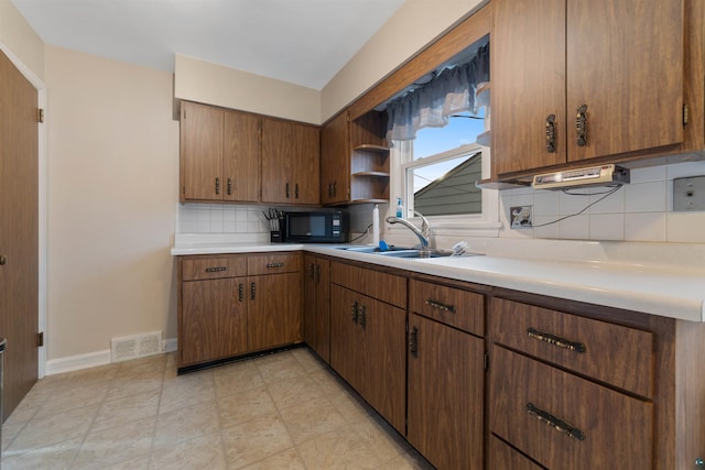 kitchen featuring sink and tasteful backsplash