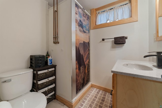 bathroom with vanity, toilet, and walk in shower