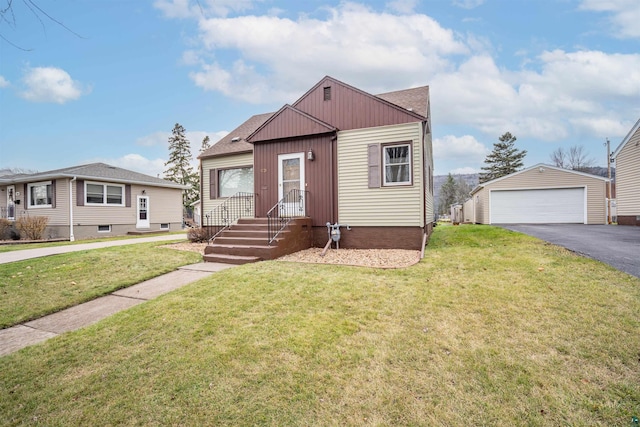 view of front facade with a front lawn, an outdoor structure, and a garage