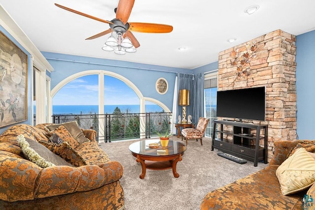 carpeted living room with ceiling fan