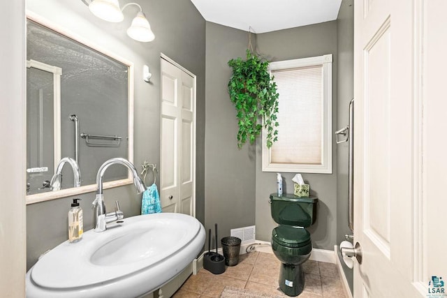bathroom featuring tile patterned flooring and toilet