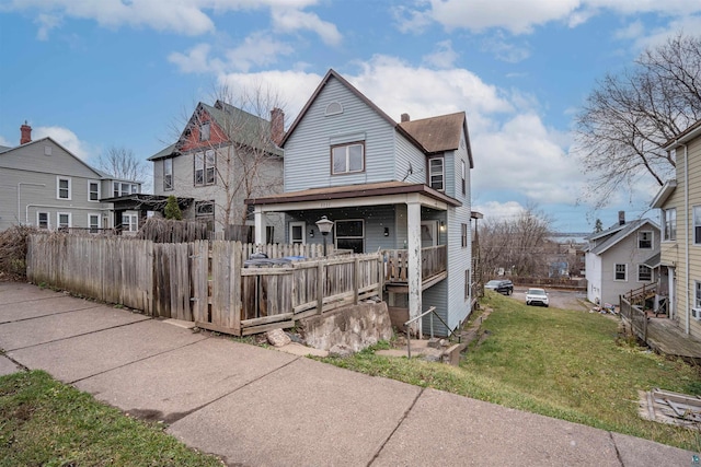 view of front of house with a porch and a front lawn