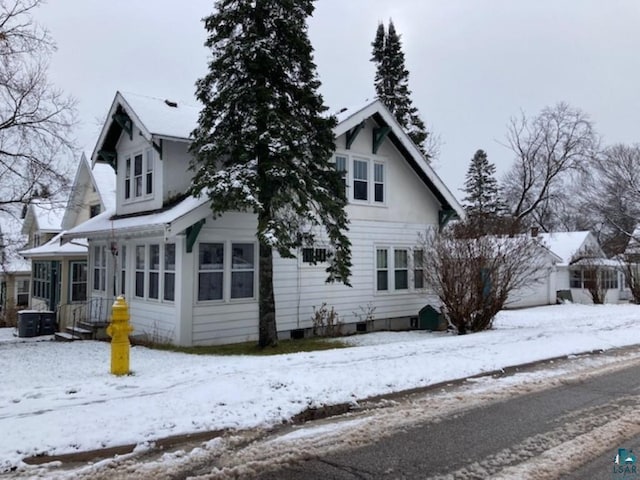 view of snow covered exterior featuring central air condition unit