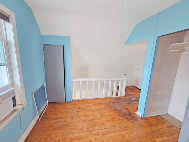 additional living space with a wealth of natural light, light hardwood / wood-style floors, and lofted ceiling