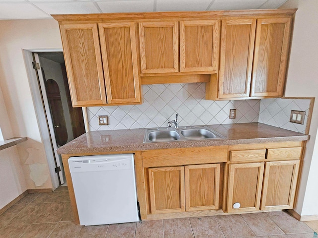 kitchen featuring tasteful backsplash, sink, white dishwasher, and a drop ceiling