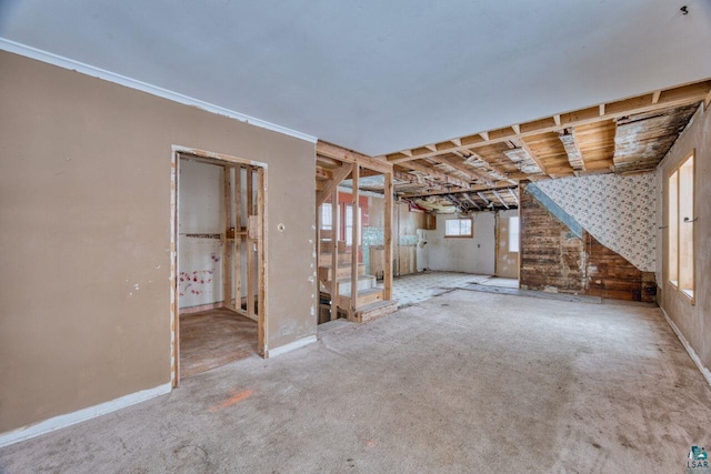 carpeted empty room featuring ornamental molding