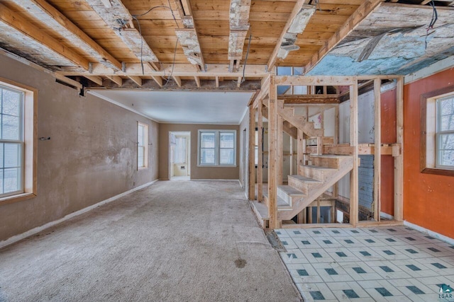 basement featuring carpet, plenty of natural light, and wooden ceiling