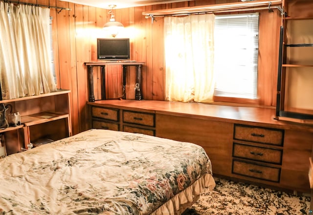 bedroom with wood walls