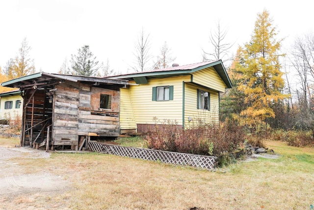 view of side of home featuring a yard