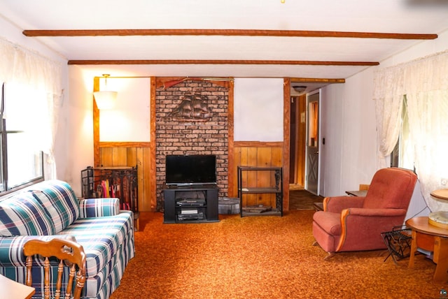 carpeted living room featuring wood walls, beamed ceiling, and a healthy amount of sunlight