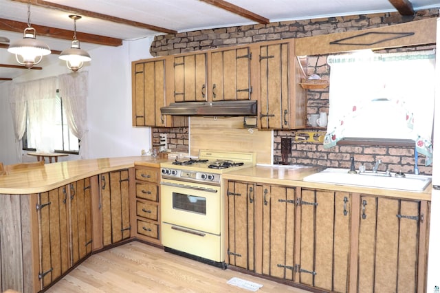 kitchen featuring sink, hanging light fixtures, light wood-type flooring, beamed ceiling, and white range oven