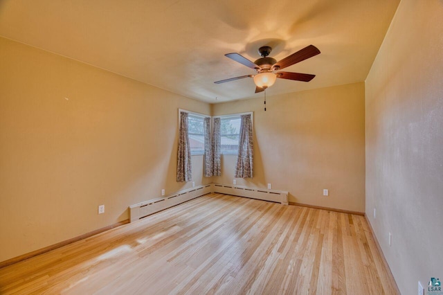 unfurnished room with ceiling fan, a baseboard heating unit, and light hardwood / wood-style flooring