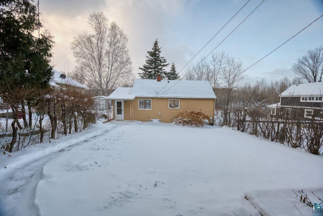 818 Douglas Ave, Eveleth, MN 55734 - snow covered house featuring a chimney