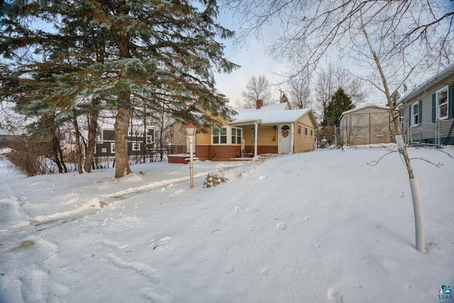 818 Douglas Ave, Eveleth, MN 55734 - view of front of property featuring a chimney and covered porch