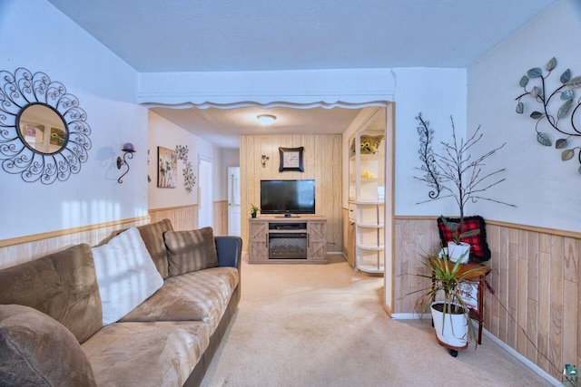 living room featuring carpet and wooden walls