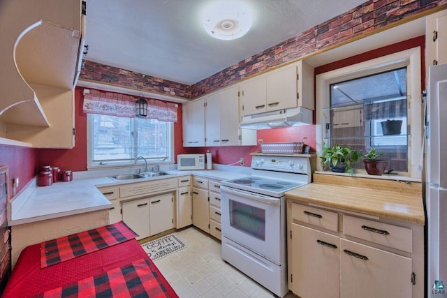 818 Douglas Ave, Eveleth, MN 55734 - kitchen with white appliances, under cabinet range hood, a sink, and light countertops