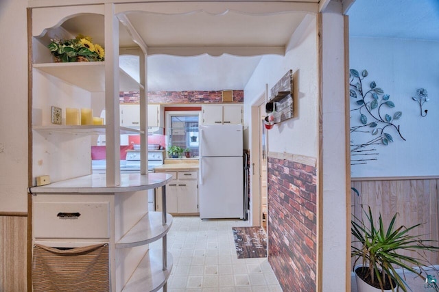 818 Douglas Ave, Eveleth, MN 55734 - kitchen featuring freestanding refrigerator, light countertops, white cabinetry, a wainscoted wall, and open shelves