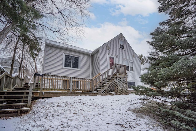 snow covered property with a wooden deck