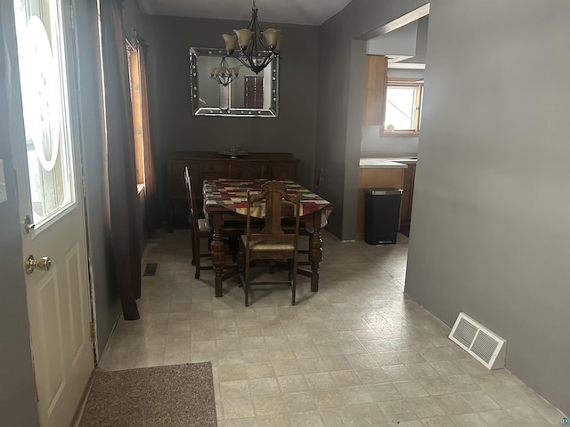 dining space with an inviting chandelier