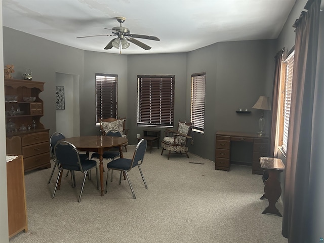 carpeted dining area featuring ceiling fan