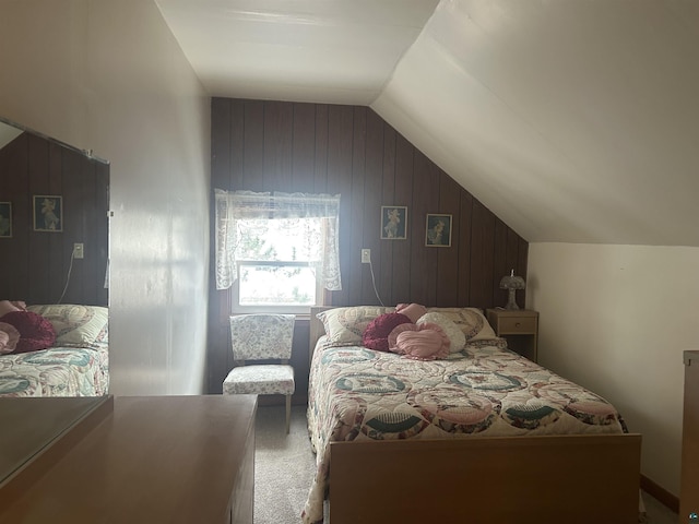 bedroom featuring carpet flooring, wooden walls, and lofted ceiling