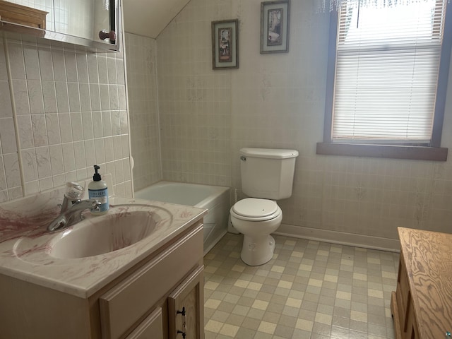 full bathroom with vanity, toilet, tile walls, and tub / shower combination