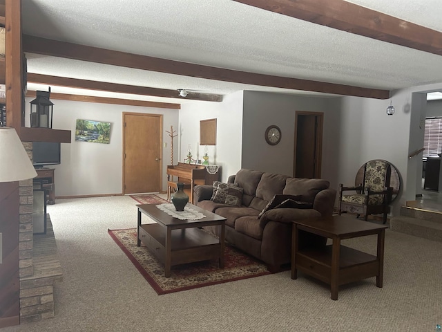 carpeted living room featuring beam ceiling and a textured ceiling