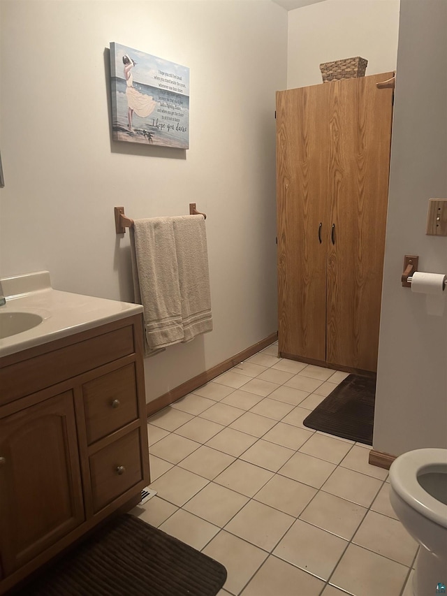 bathroom featuring tile patterned floors, vanity, and toilet