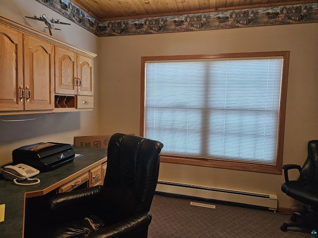 carpeted office with a baseboard heating unit, built in desk, and wooden ceiling