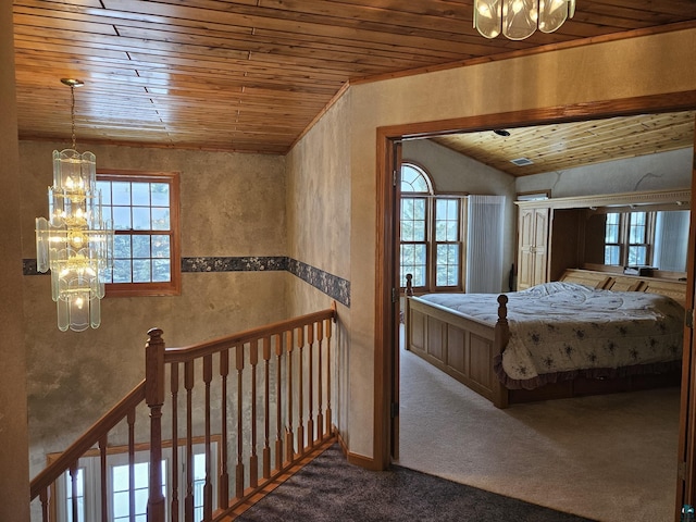 carpeted bedroom featuring an inviting chandelier, wooden ceiling, and vaulted ceiling