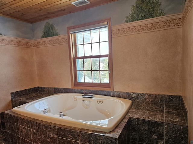 bathroom with tiled bath and wood ceiling