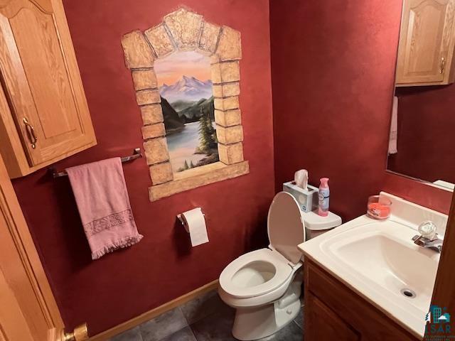 bathroom with tile patterned floors, vanity, and toilet