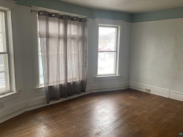 empty room featuring dark hardwood / wood-style flooring